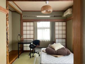 Postel nebo postele na pokoji v ubytování 北アルプス麓のゲストハウス林屋