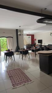 a room with tables and chairs and a living room at Cora's Boutique Bed & Breakfast in Swakopmund