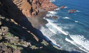 an aerial view of the ocean and a mountain at Albergue Montes de Anaga in El Bailadero