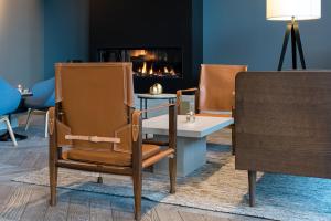 a room with two chairs and a fireplace at Clarion Hotel Air in Sola