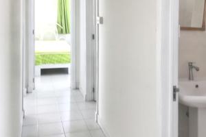 a white hallway with a sink and a bathroom at Charming Apartment, Pereybere, Terrace in Pereybere +23 photos