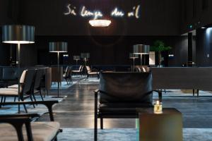 a dining room with chairs and tables and lights at Clarion Hotel Air in Sola