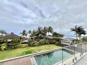 an image of the balcony of a house with a swimming pool at Coral Residence Luxury Villa in Vieux Grand Port