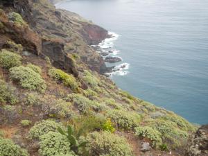 a view of the ocean from the side of a mountain at Albergue Montes de Anaga in El Bailadero