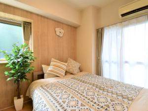 Letto o letti in una camera di Alphabed福山西桜町
