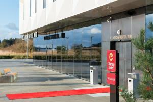 a building with a parking lot with a sign in front of it at Clarion Hotel Air in Sola