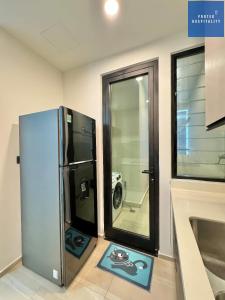 a kitchen with a refrigerator in a room at D'Edge Thao Dien - SkyPool Paradise in Ho Chi Minh City