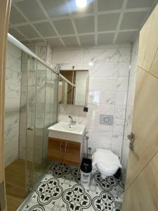 a bathroom with a sink and a toilet at Grand Bektas Suite in Trabzon