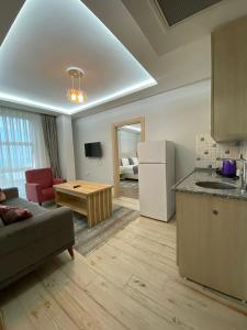 a kitchen and living room with a couch and a table at Grand Bektas Suite in Trabzon +17 photos