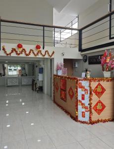 a hall with a table with a sign on it at Jogja Amor Hotel in Demangan +43 photos
