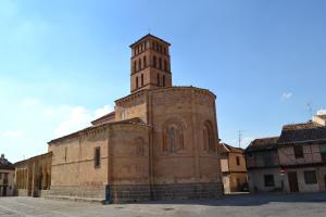 an old building with a clock tower on a street at The Factory Residence Hall in Segovia