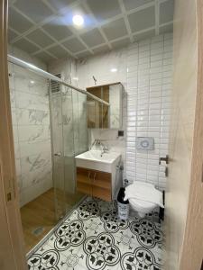 a bathroom with a sink and a shower and a toilet at Grand Bektas Suite in Trabzon