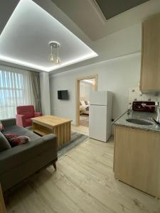 a living room with a couch and a kitchen at Grand Bektas Suite in Trabzon