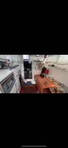 a kitchen with a stove and a table in it at vacances de rêve sur les vagues in Gruissan