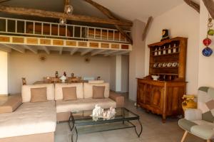 a living room with a couch and a loft at La grange des vignes in Pomport