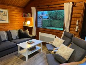 a living room with a couch and chairs and a table at Lüttje Koje in Spieka-Neufeld +14 photos