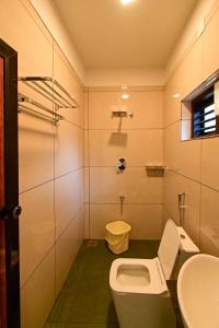 a bathroom with a toilet and a sink at San WAYANAD HOMESTAY AND SERVICE VILLA in Sultan Bathery +29 photos