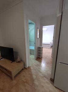 a living room with a table and a television in it at Espanhouse Diana bungalow in La Mata