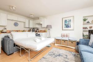 a living room with a couch and a table at Stoney Creek Cottage - Crail in Crail