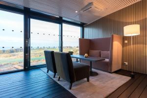 a room with a table and chairs and large windows at Clarion Hotel Air in Sola