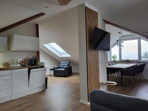 a kitchen and a living room with a dining room at Haus EDDA - Ferienwohnungen mit Garten und Schlossblick in Marburg an der Lahn