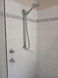 a shower in a white tiled bathroom at Ocean breeze villa in Preston Beach +30 photos