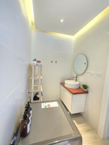 a bathroom with a sink and a mirror on the wall at Beautiful Apartment 10 min from Bayahibe beach Las Terrazas in Bayahibe