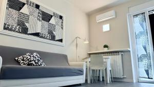 a living room with a couch and a table at Miraflowers Home in Turin