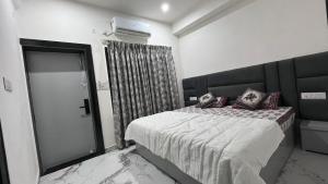 a bedroom with a large bed and a glass door at Luxe 2 BHK Apartment in Orchha +91 photos