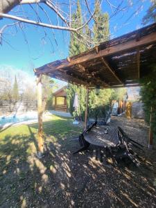 a picnic table under a pergola in a yard at Casa Madera Urbanizacion Socorro in Seville