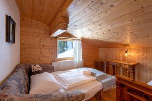 a bedroom with a bed in a wooden cabin at Au Alm Appartements in Söll +6 photos