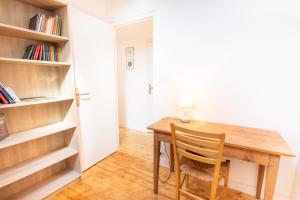 a wooden table with a chair in a room at Tasmannia - 3 étoiles avec piscine chauffée - Erquy in Erquy