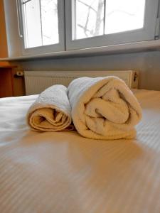 a couple of towels sitting on top of a bed at Pod starymi lipami in Szczecin +53 photos