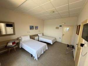 a hospital room with two beds and a television at Hotel Bahía by ALEGRIA in Puerto de Mazarrón