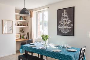 a dining room table with a blue table cloth on it at La Lancieutine - A 300 mètres de la plage in Lancieux