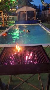 a fire grill in a swimming pool at night at Rowlands Way 3 in Ţegheş