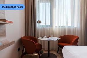 a room with a table and two chairs and a bed at The Social Hub Amsterdam City in Amsterdam +37 photos