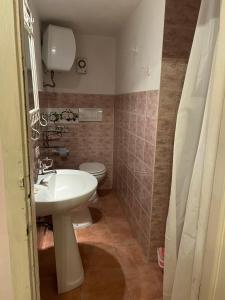 a bathroom with a white sink and a toilet at Appartamento Giallo in Rio Marina +13 photos