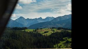 a view of a valley with mountains and trees at Domki GliczarowSKI z Jacuzzi & Sauna in Zakopane +104 photos