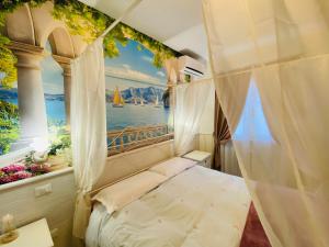 a bedroom with a bed and a window with a sailboat at Villa Poggio Ulivo Pool-Apartments in Rivoli Veronese +121 photos
