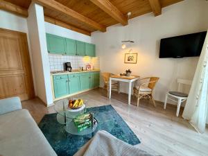 a living room with a couch and a table at Ferienwohnung Bachl inkl. Chiemgaukarte in Ruhpolding