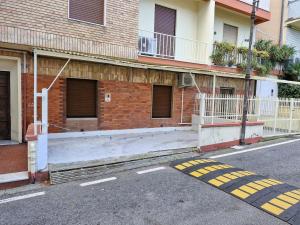 an empty parking lot in front of a building at New apartment next to the beach in Laigueglia