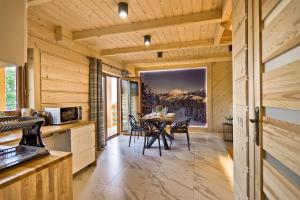 a kitchen and dining room with a table and chairs at Domki GliczarowSKI z Jacuzzi & Sauna in Zakopane