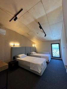 a room with two beds and a window at Camp Hotel Pura Vida in Tbilisi City +40 photos
