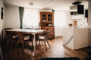 a kitchen and dining room with a table and chairs at Casa Kaiserstuhl Spätburgunder in Vogtsburg +15 photos