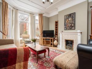 a living room with a couch and a fireplace at Pass the Keys Spacious and Comfortable 3 Bed Home in Birkenhead in Birkenhead