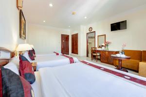 Postel nebo postele na pokoji v ubytování Hùng Phong Hotel - Near Dalat Market