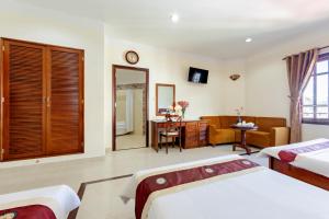 Postel nebo postele na pokoji v ubytování Hùng Phong Hotel - Near Dalat Market