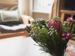 a vase filled with flowers on a table at Pass the Keys Spacious and Comfortable 3 Bed Home in Birkenhead in Birkenhead