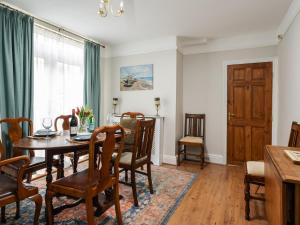 a dining room with a table and chairs at Pass the Keys Spacious and Comfortable 3 Bed Home in Birkenhead in Birkenhead